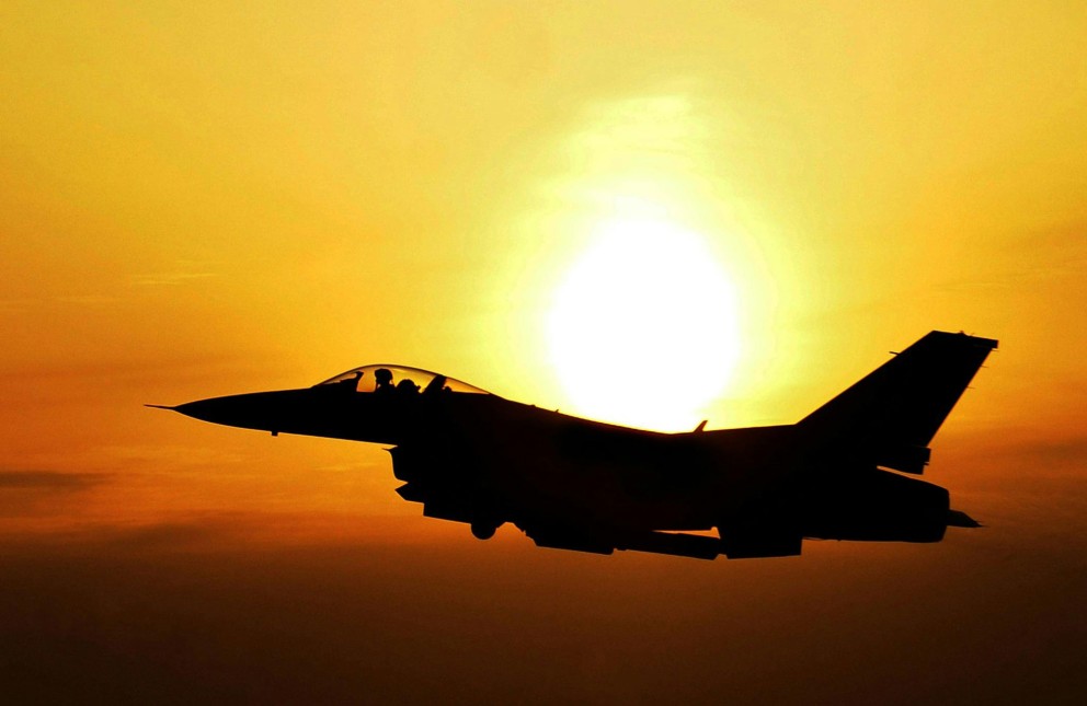 fighter jet at sunset